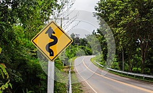 Curvy road sign to the mountain