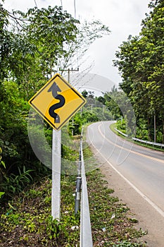 Curvy road sign to the mountain