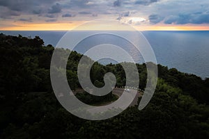 Curvy road winds towards Black sea, with sunset reflecting on water, georgia