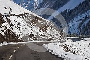 A curvy winding road passing through snow covered mountains of Himalayas at Drass. Srinagar-Leh Highway. BEACON. BRO. NHAI