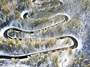 Curvy windy road in snow covered forest