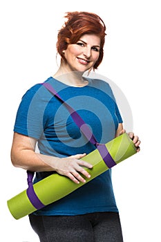 Curvy woman carrying yoga mat