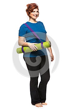 Curvy woman carrying yoga mat