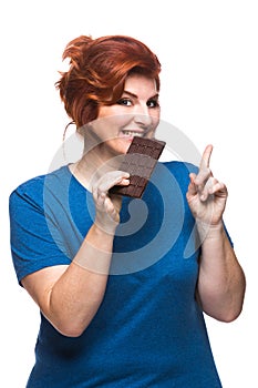 Curvy woman eating chocolate