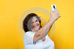 Curvy young woman using technology with tablet and mobile phone