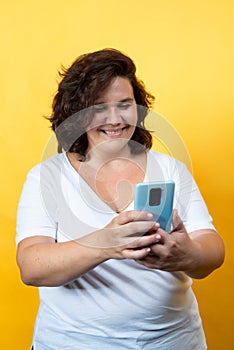 Curvy young woman using technology with tablet and mobile phone