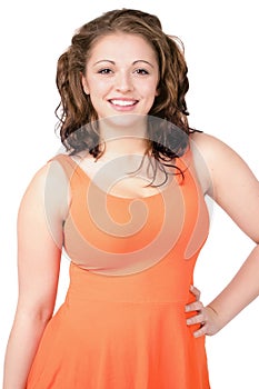 Curvy young woman wearing orange dress, happy smile.