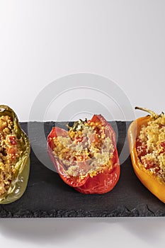 Cuscus, roasted peppers in the oven and stuffed with couscous with vegetables white background