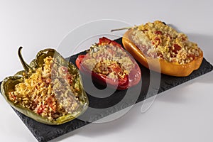 Cuscus, roasted peppers in the oven and stuffed with couscous with vegetables white background