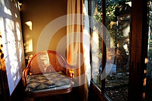 Cushioned chair beside glass door and paper wall in Japanese building