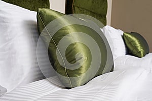 Cushions , Green pillows on bed in a hotel room