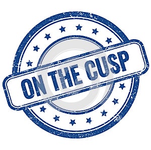 ON THE CUSP text on blue grungy round rubber stamp photo