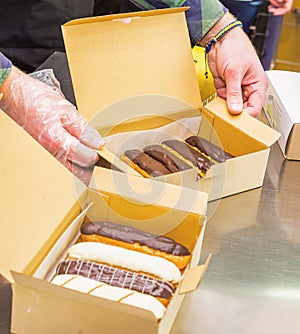 Custard eclairs with dark and light chocolate in a box