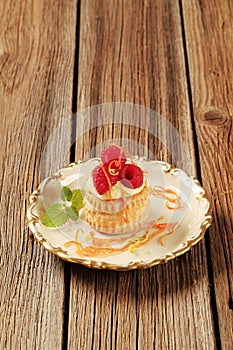 Custard filled puff pastry shell with raspberries