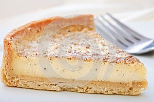 Custard tart slice on a plate.