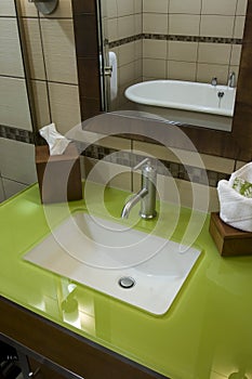 Custom bathroom with green glass countertops