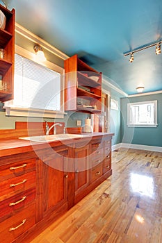 Custom build cherry kitchen with blue walls