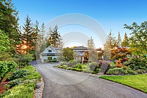 Custom built luxury house with long concrete driveway.