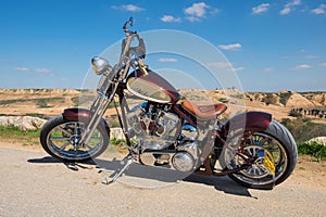 Custom Chopper motorcycle on desert and blue sky background