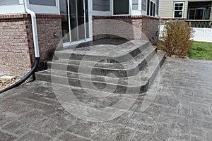 Custom concrete stamped patio with gray color added photo