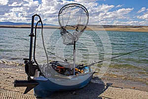 Custom fishing kayak with an electric trolley motor on shore of  Lake Hattie, Wyoming