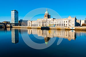 Custom House and Liberty Hall reflecting on river Liffey in Dublin