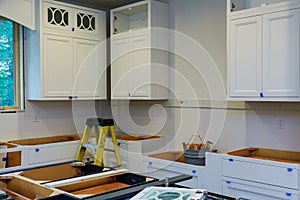 Custom kitchen cabinets in various stages of installation base for island in center