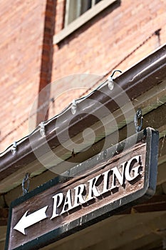 Custom Parking sign with arrow on side of building