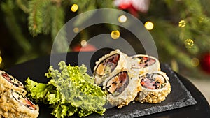 Custom sushi roll in tempura with nori, fresh salmon, tuna, avocado, masago caviar, drizzled with pineapple sauce with