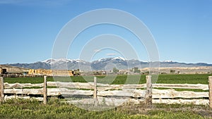 Custom wood fence and snow covered Idaho mountains