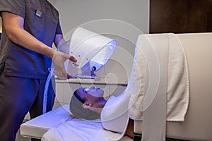 Customer in a beauty salon having a session of phototherapy