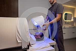 Customer in a beauty salon having a session of phototherapy
