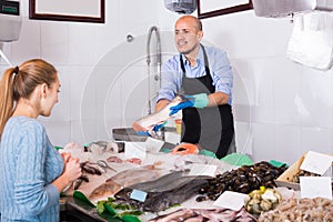 Customer buying cooled fish in fishery