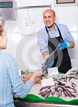 Customer buying cooled fish in fishery