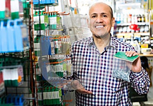 Customer buying nails and clinkers in store. photo