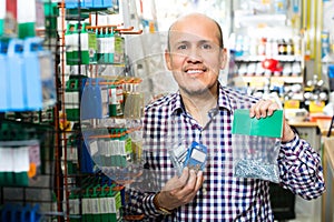 Customer buying nails and clinkers in store photo