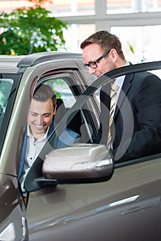 Customer buying new car in auto dealership