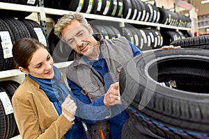 Customer in car store buying tires