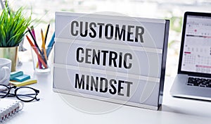 Customer centric mindset text with work table.business service