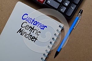 Customer Centric Mindset write on a book isolated on Office Desk photo