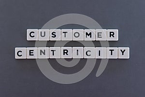 Customer Centricity word made of square letter word on grey background