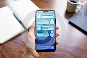 Customer and chatbot dialog on smartphone screen. AI. Artificial intelligence and service automation technology concept.