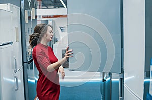 Customer choosing large fridges in domestic appliances section