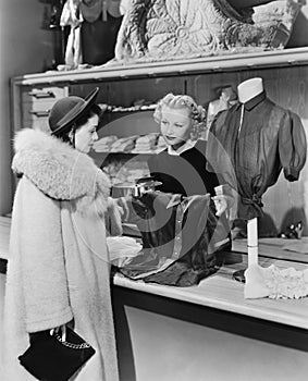 Customer and clerk in clothing store photo