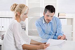 Customer and client sitting at desk or business people talking a