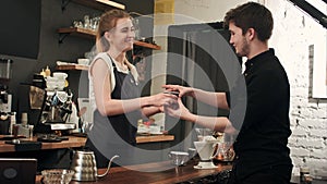 Customer at counter of coffee shop waiting for coffee