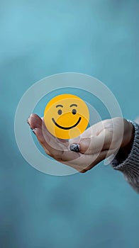 Customer delight Womans hand holds happy face icon, positive experience
