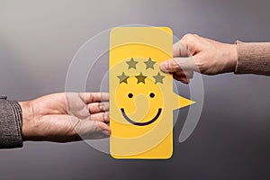 Customer Experience Concept. Happy Client giving a Five Star Rating and Smiling Face Feedback on Bubble Speech Card