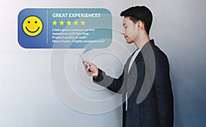 Customer Experience Concept. Young Businessman Reading a Positive Review via Smartphone photo