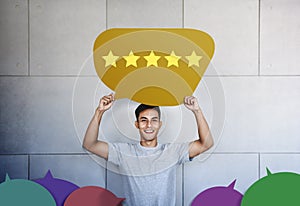 Customer Experience Concept. Young Man with Happy Face Showing Five Star Services Rating Satisfaction on Speech Bubble Card